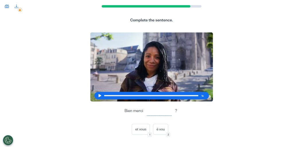Busuu exercise showing a video of a woman near a Gothic cathedral with a fill-in-the-blank spelling exercise below